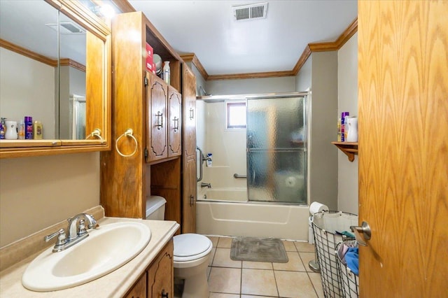 bathroom with ornamental molding, toilet, tile patterned floors, vanity, and combined bath / shower with glass door