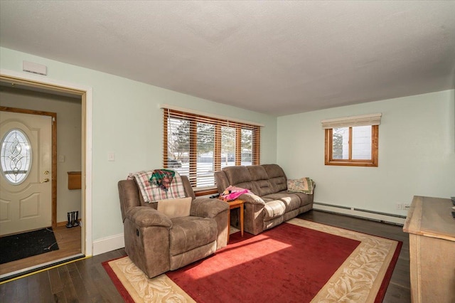 living room with a baseboard heating unit, wood finished floors, and baseboards