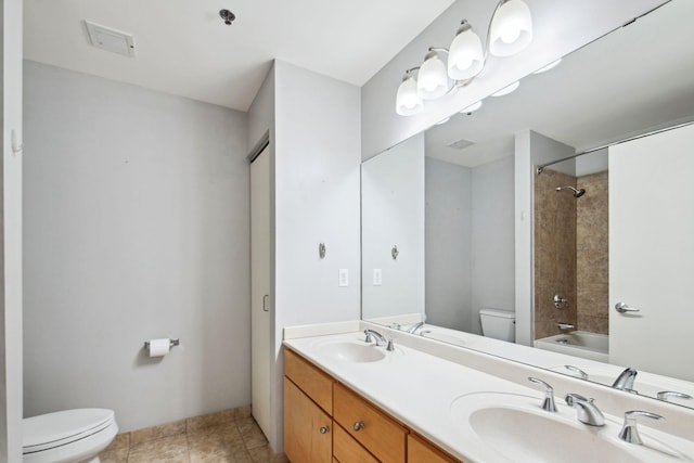 bathroom featuring  shower combination, a sink, toilet, and double vanity