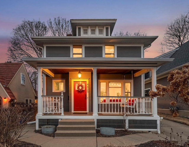 american foursquare style home with covered porch and central AC