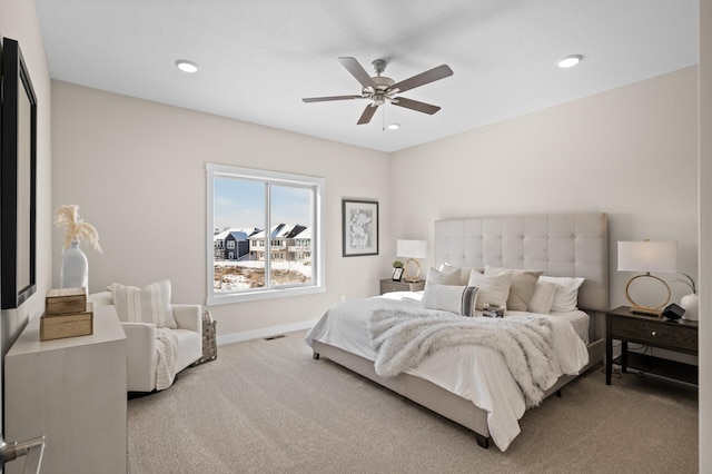 bedroom with ceiling fan and light colored carpet