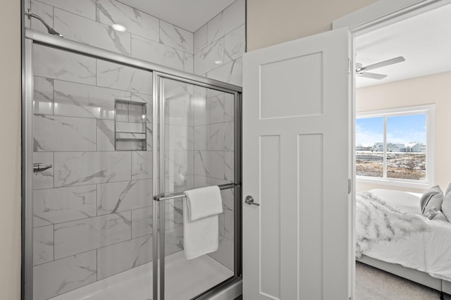 bathroom featuring a shower with shower door and ceiling fan