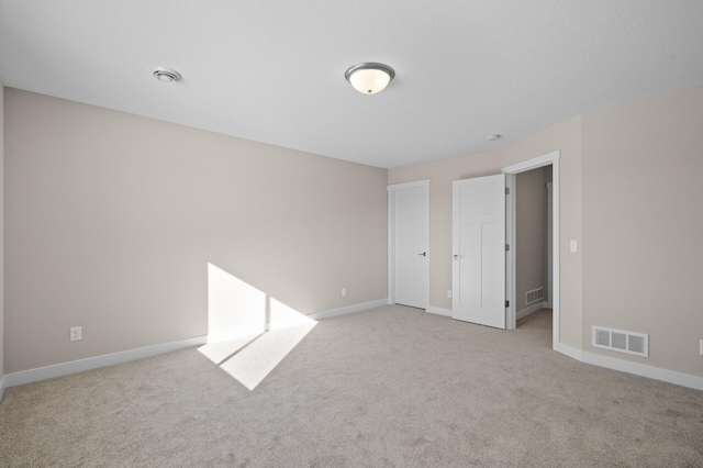 empty room featuring light colored carpet