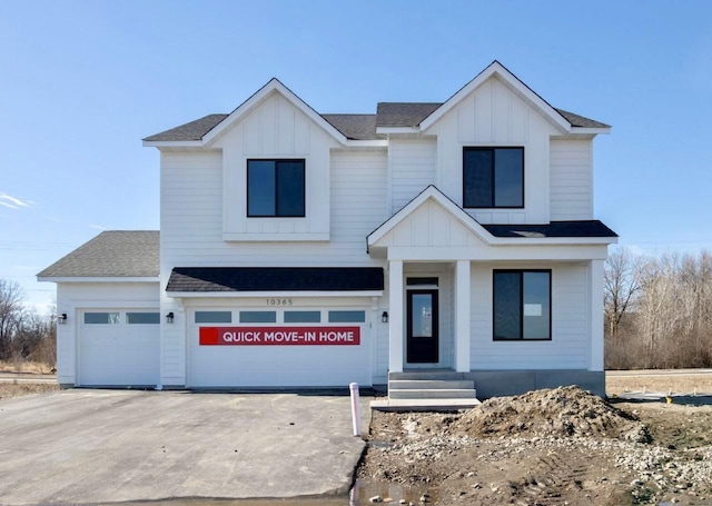 modern inspired farmhouse with concrete driveway, a shingled roof, and board and batten siding