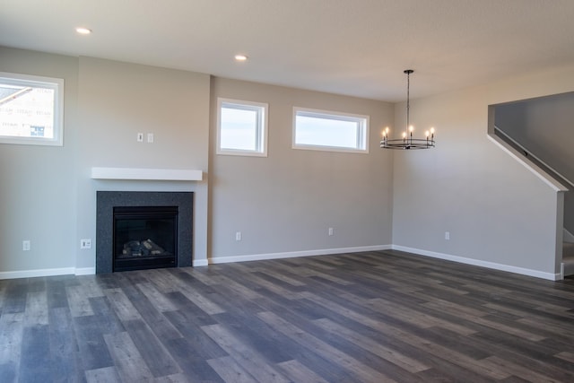 unfurnished living room with dark wood finished floors and a healthy amount of sunlight