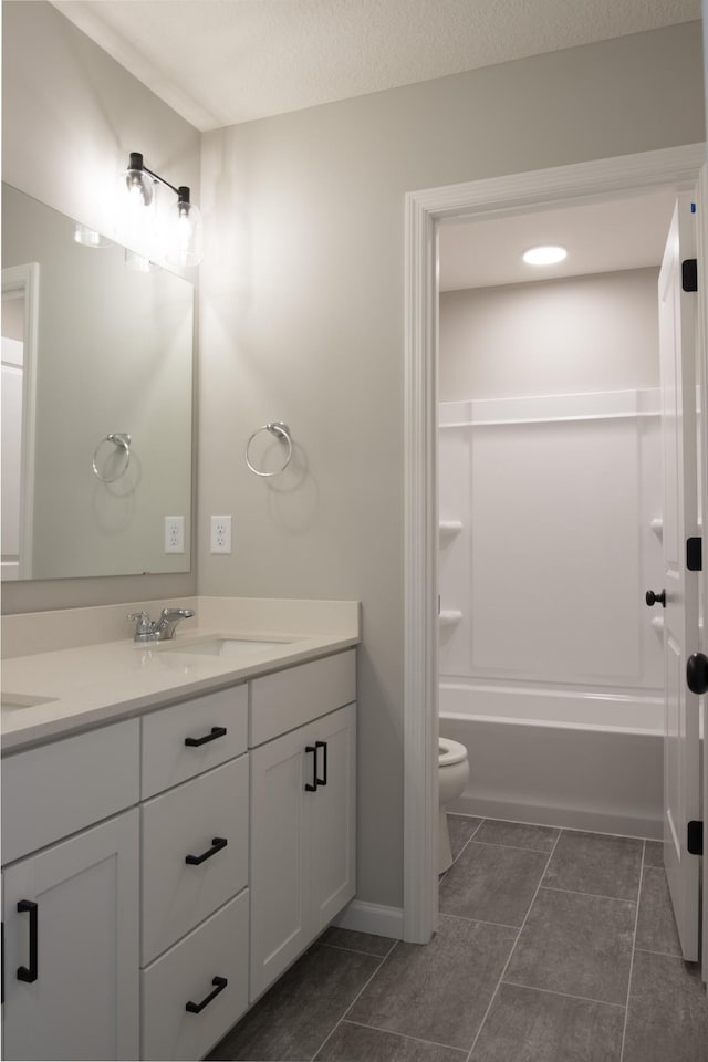 full bath featuring tile patterned flooring, vanity, and toilet