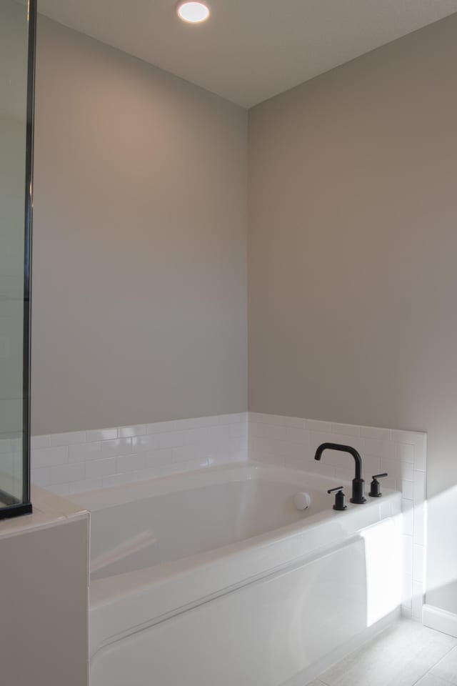 bathroom featuring a garden tub and recessed lighting