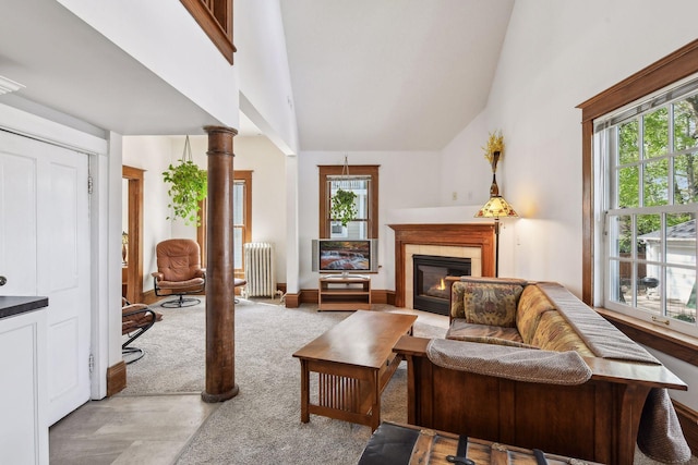 interior space with ornate columns, plenty of natural light, radiator heating unit, and a tile fireplace