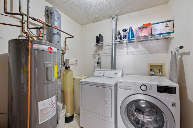 laundry room with laundry area, separate washer and dryer, a textured ceiling, and electric water heater