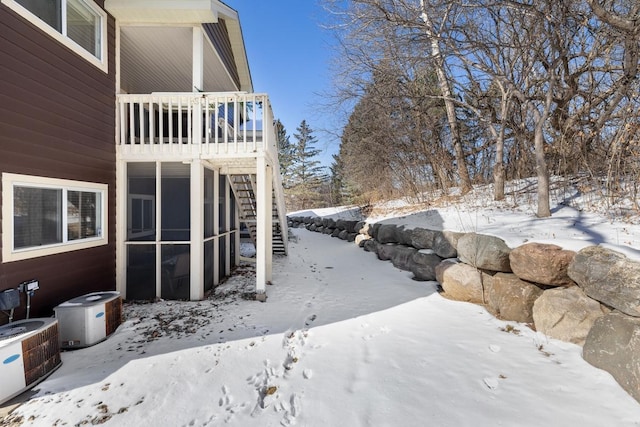 yard covered in snow featuring stairs and cooling unit