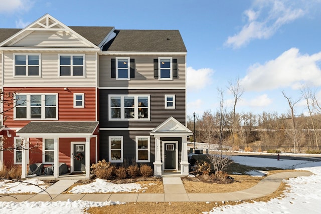 multi unit property featuring a shingled roof