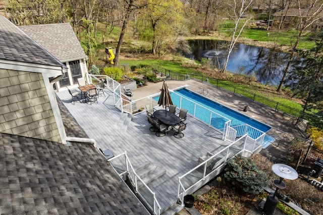 view of pool with a deck with water view