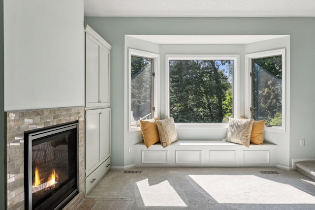 interior space with a tiled fireplace