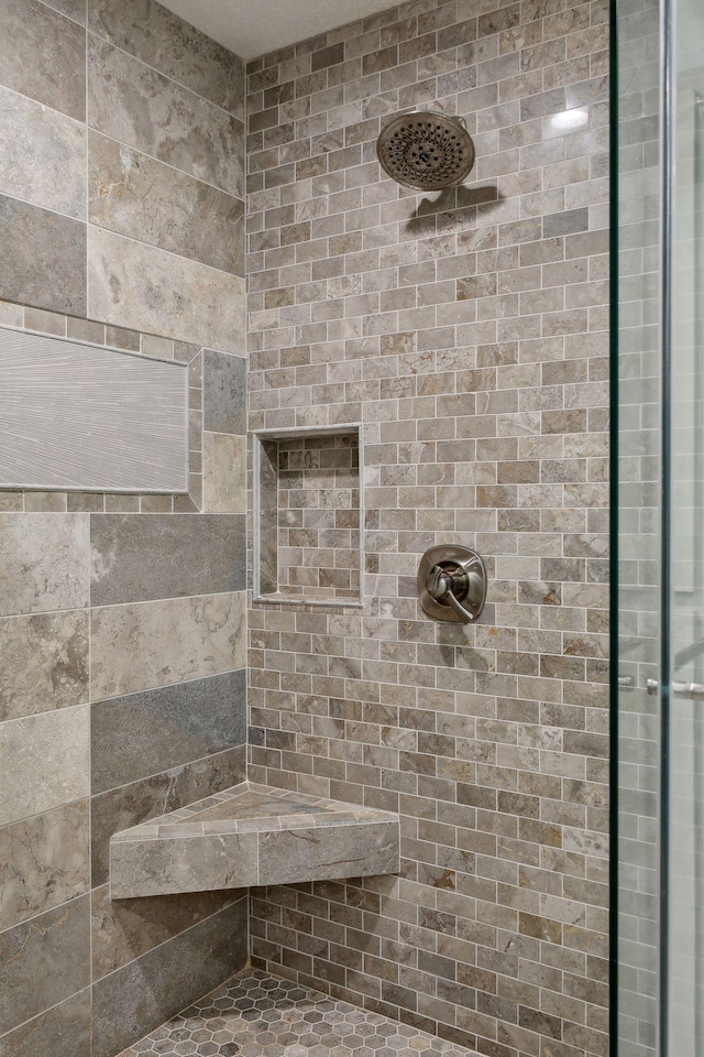 bathroom with tiled shower