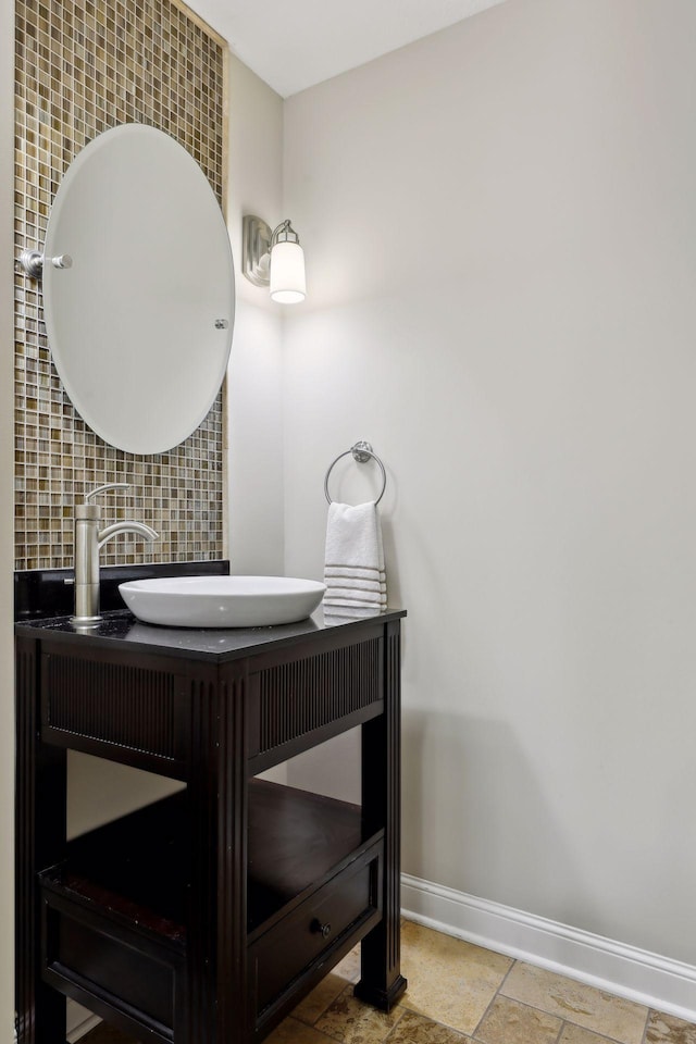 bathroom featuring vanity and backsplash