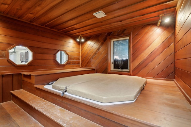 interior space featuring wood ceiling and wooden walls