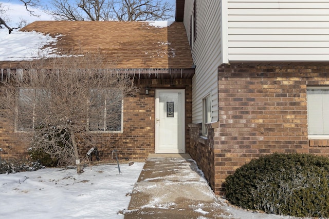 view of snow covered property entrance