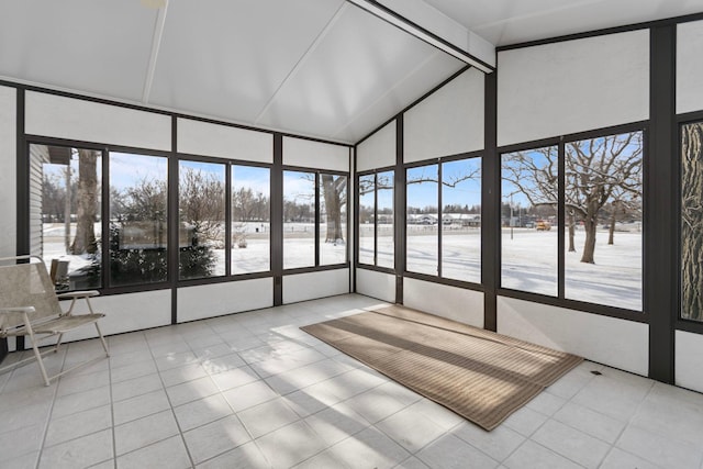 unfurnished sunroom featuring vaulted ceiling with beams