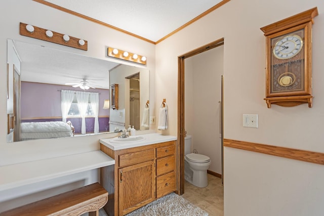 bathroom featuring vanity, ceiling fan, crown molding, and toilet