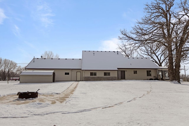 view of snow covered rear of property