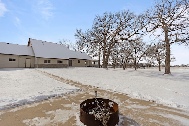 snowy yard with an outdoor fire pit