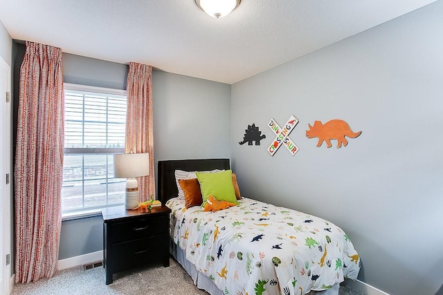 carpeted bedroom featuring a textured ceiling