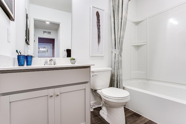 full bathroom with shower / tub combo with curtain, vanity, toilet, and hardwood / wood-style floors