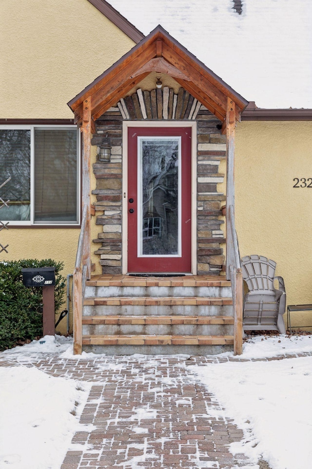 view of snow covered property entrance