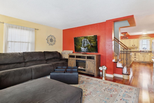 living room featuring hardwood / wood-style flooring and sink