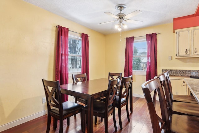 dining room with hardwood / wood-style flooring, ceiling fan, and a textured ceiling