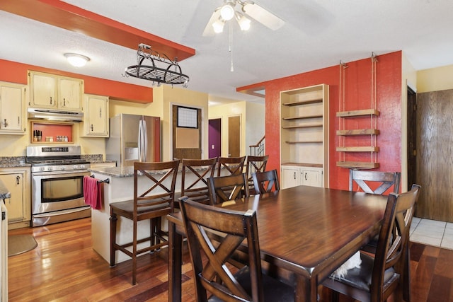 dining area featuring ceiling fan, a textured ceiling, and light wood-type flooring