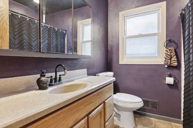 bathroom featuring vanity, toilet, and tile patterned flooring