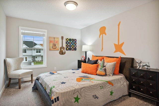 bedroom with carpet floors and a textured ceiling