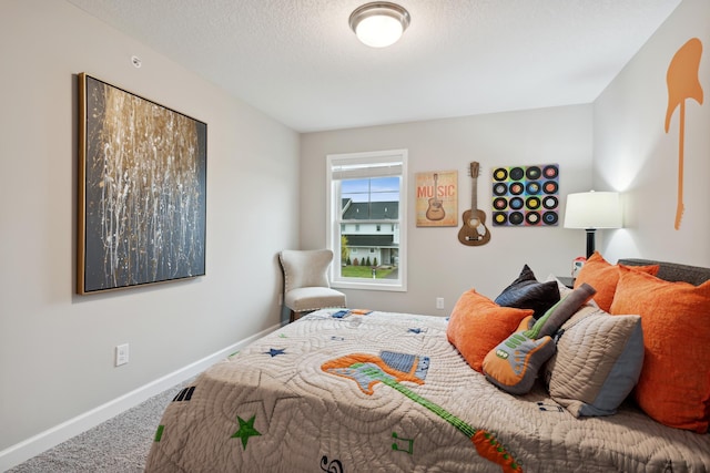 bedroom with carpet and a textured ceiling