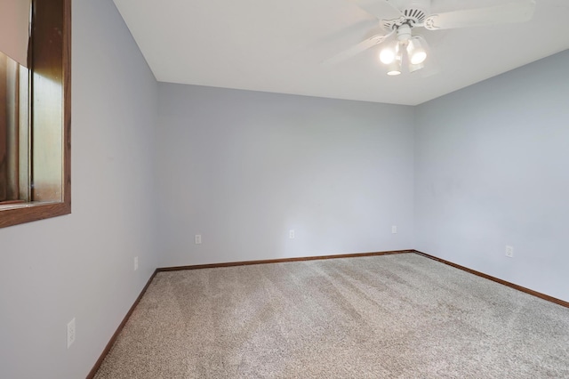 spare room with ceiling fan and carpet