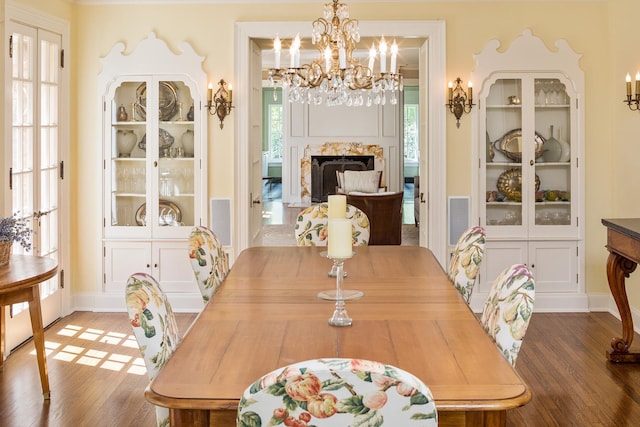 dining room featuring a premium fireplace, dark hardwood / wood-style flooring, and a chandelier