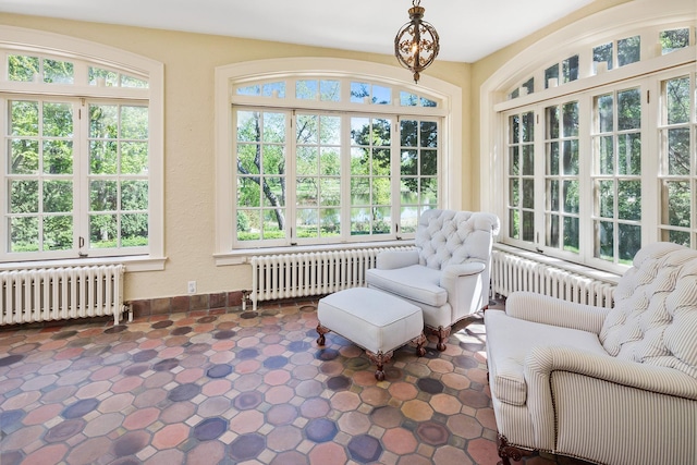 sunroom / solarium featuring a wealth of natural light and radiator heating unit