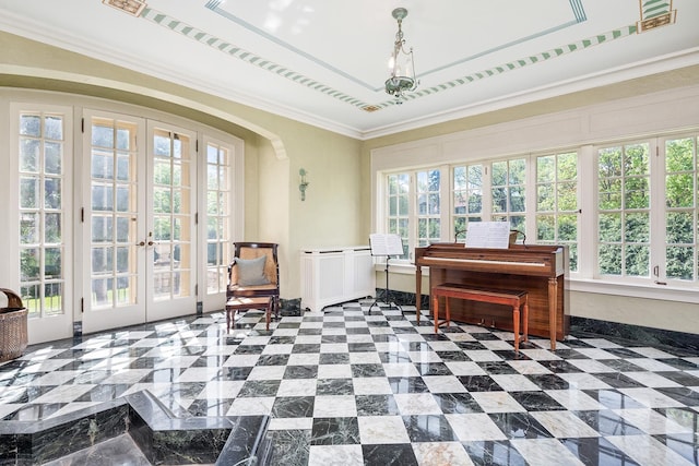 interior space with a raised ceiling, ornamental molding, and french doors