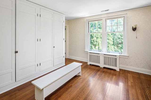 interior space with radiator and dark hardwood / wood-style floors