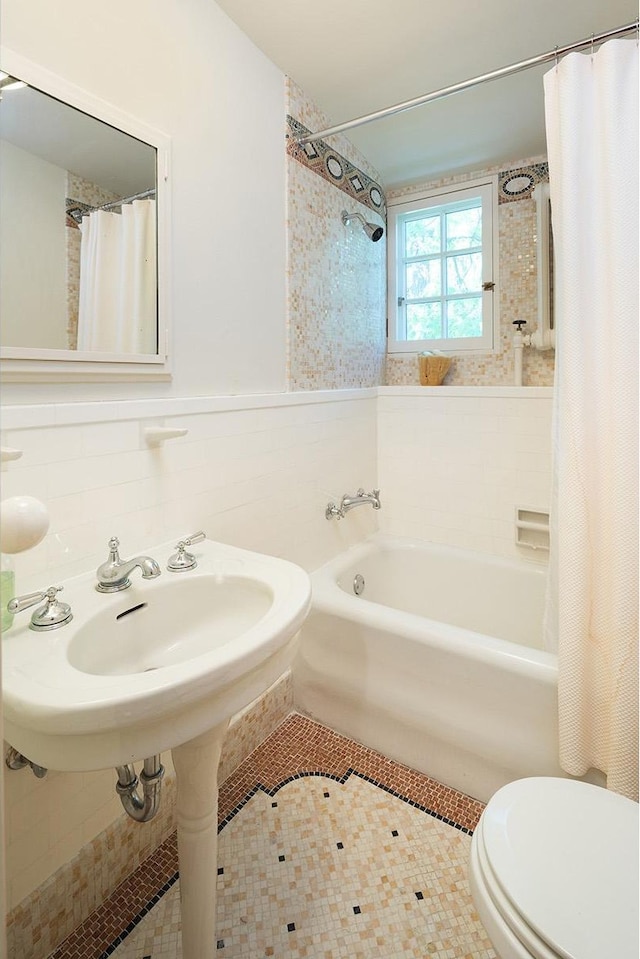 bathroom featuring shower / bath combination with curtain, toilet, and tile patterned flooring