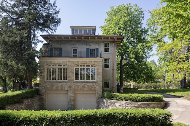 view of front of property with a balcony and a garage