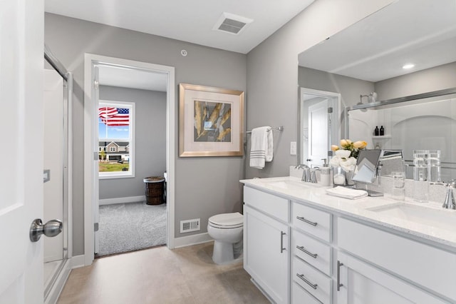 bathroom featuring vanity, toilet, and a shower with shower door