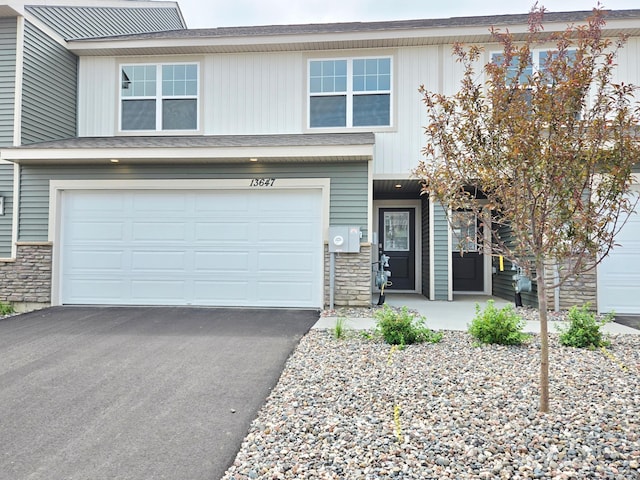 13647 Kaylemore Trl, Rosemount, MN 55068 - view of front of home featuring stone siding, a garage, driveway, and a porch