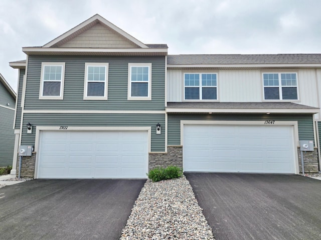 13647 Kaylemore Trl, Rosemount, MN 55068 - view of front facade featuring stone siding, an attached garage, and asphalt driveway