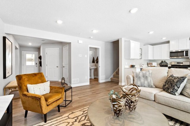 13647 Kaylemore Trl, Rosemount, MN 55068 - living room with stairway, light wood finished floors, and recessed lighting