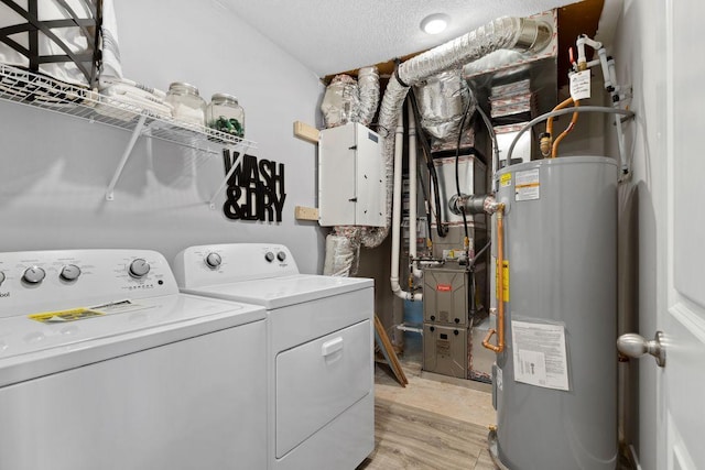 13647 Kaylemore Trl, Rosemount, MN 55068 - washroom with water heater, washing machine and dryer, a textured ceiling, and light wood-type flooring