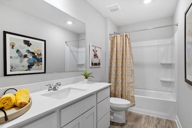 13647 Kaylemore Trl, Rosemount, MN 55068 - full bathroom featuring vanity, wood finished floors, shower / tub combo with curtain, and recessed lighting