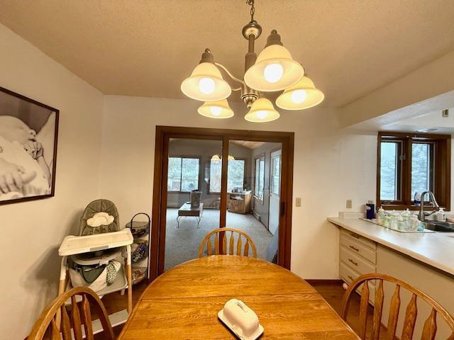 dining space with a notable chandelier, french doors, and dark wood-type flooring