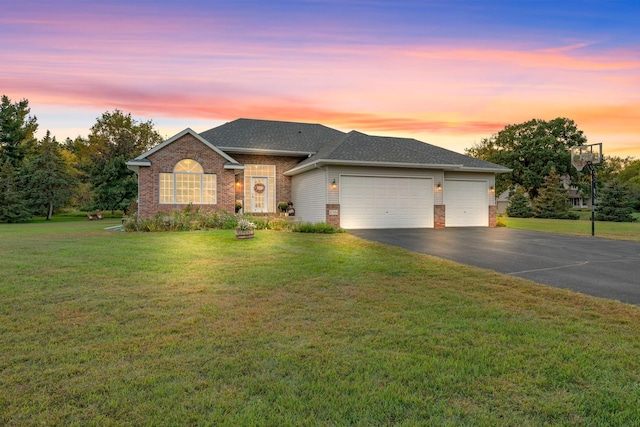 prairie-style home with a garage and a lawn