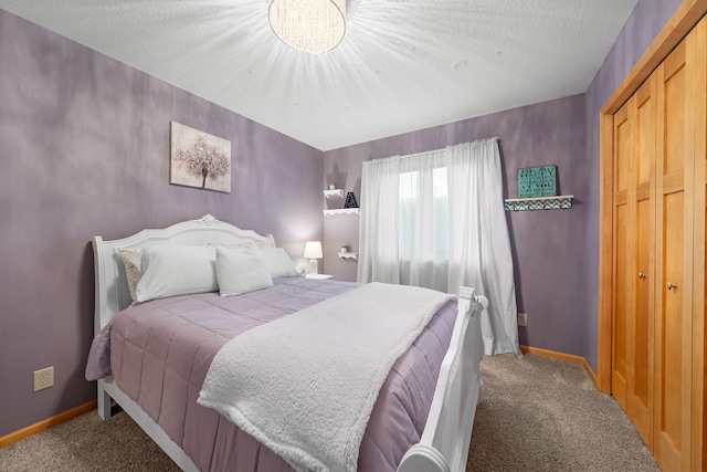 bedroom with a closet, carpet, and a textured ceiling